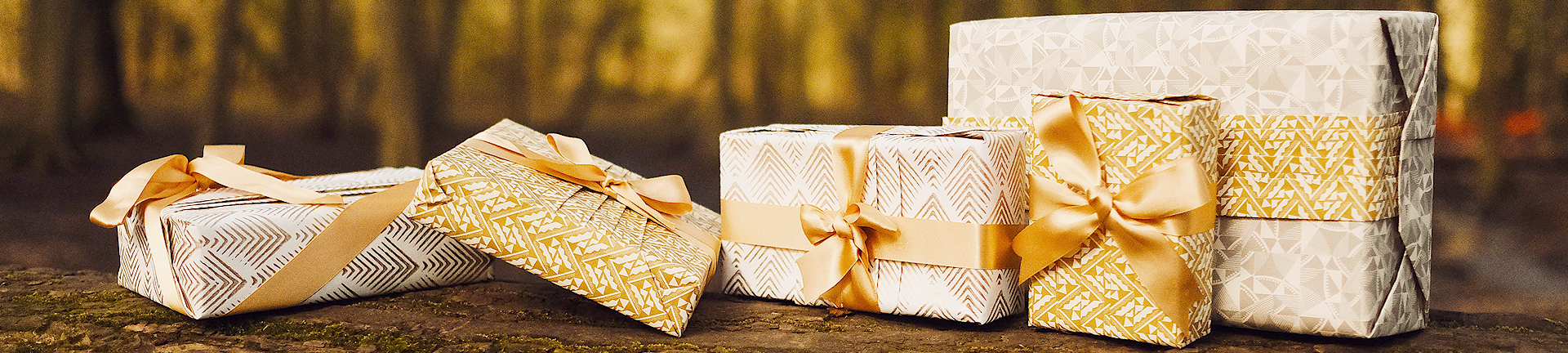 Gold and white gifts professionally wrapped in premium environmentally friendly wrapping paper 