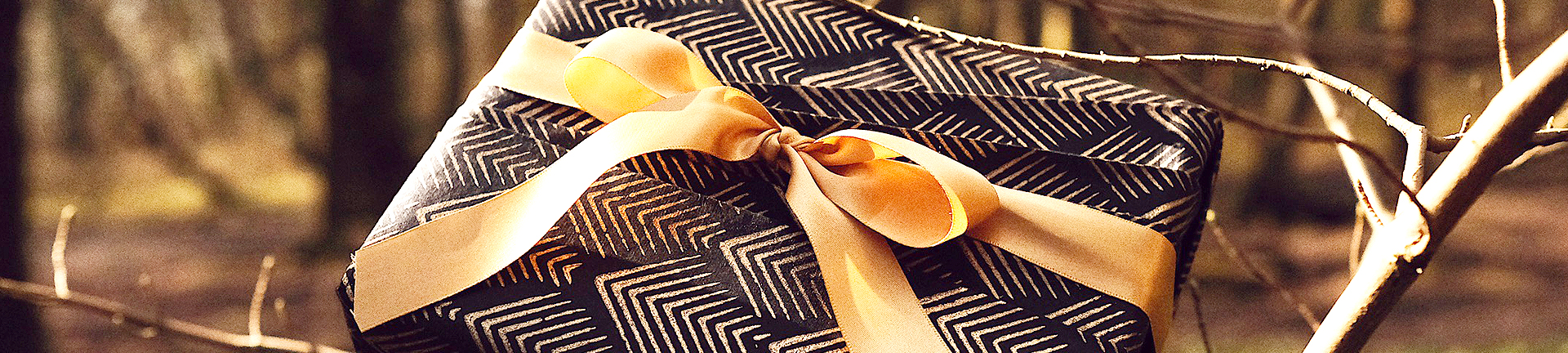 Gold and white gifts professionally wrapped in environmentally friendly premium wrapping paper