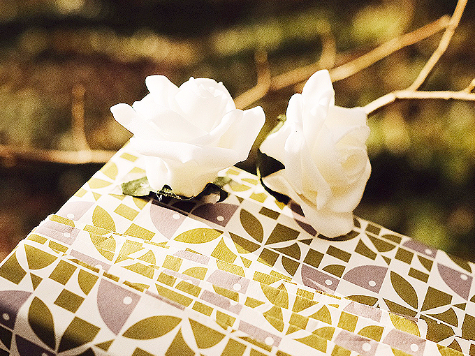 Personally wrapped gift in premium white, gold, silver and paper with white roses